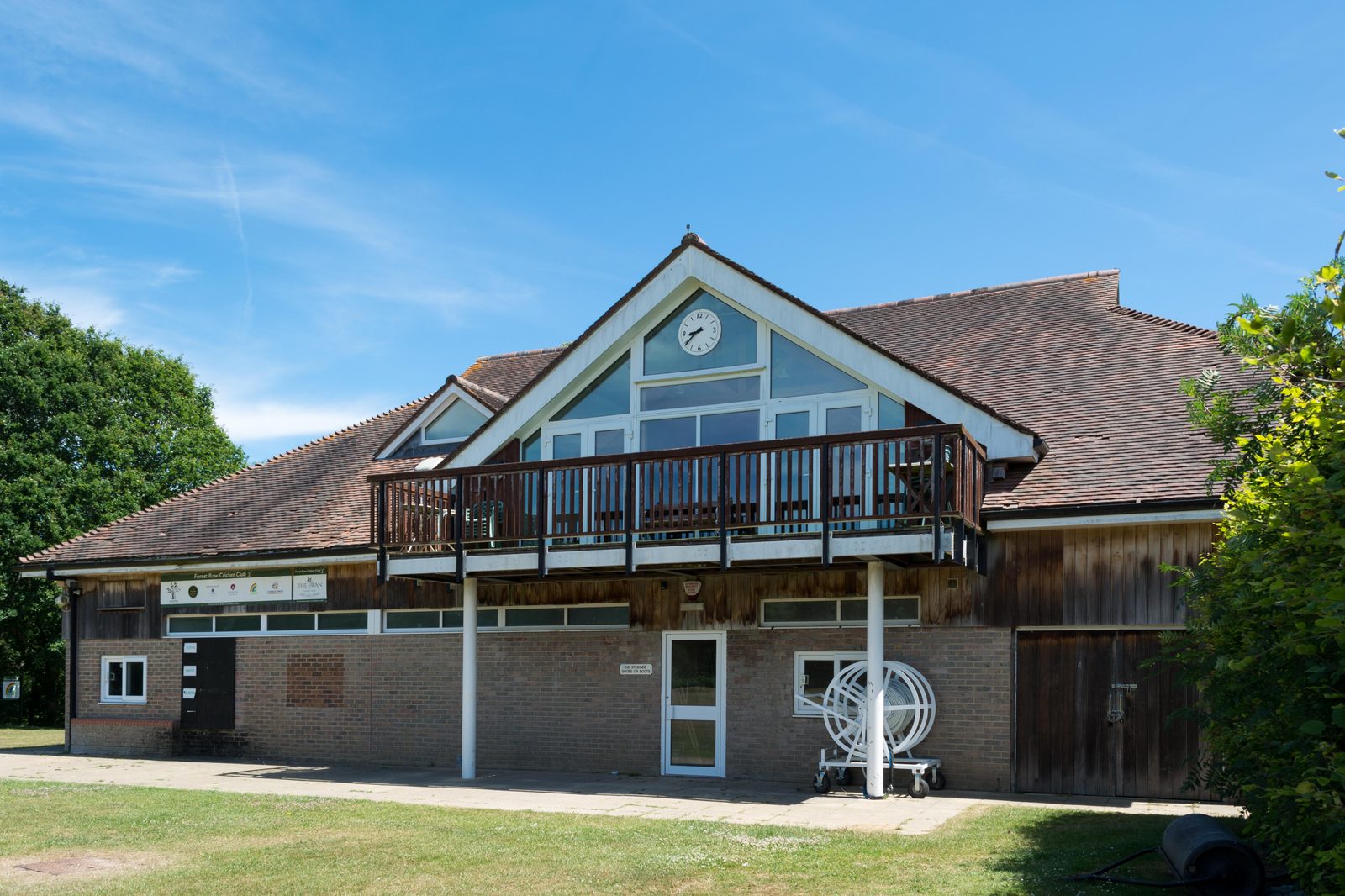 The Memorial Pavilion exterior on a sunny day, with its distinctive clock, balcony and cricket club signage